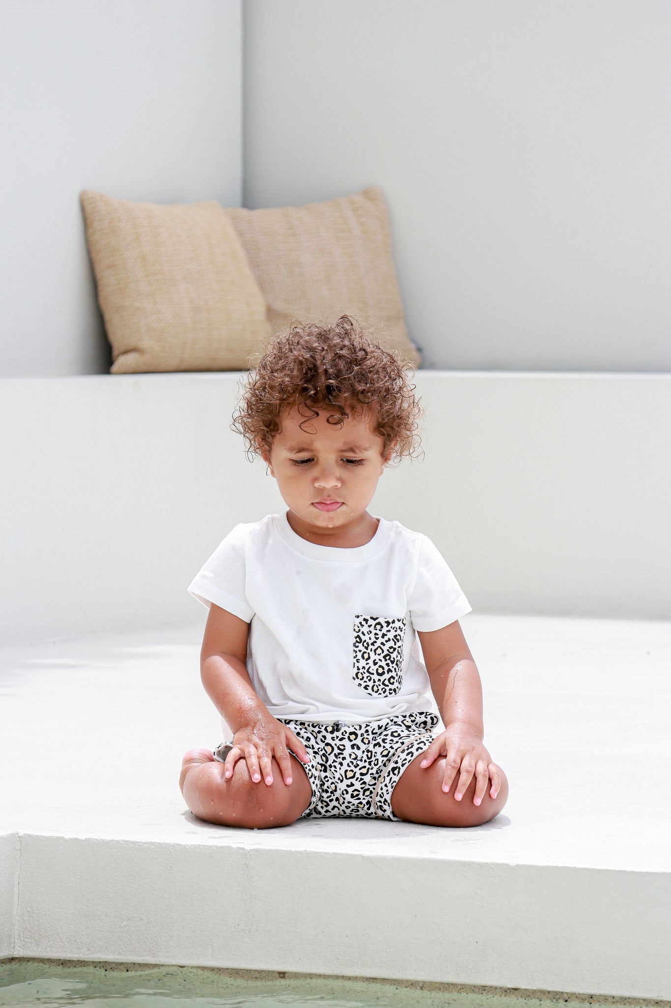 Kid wearing a leopard print pocket tee, showcasing a stylish and casual look