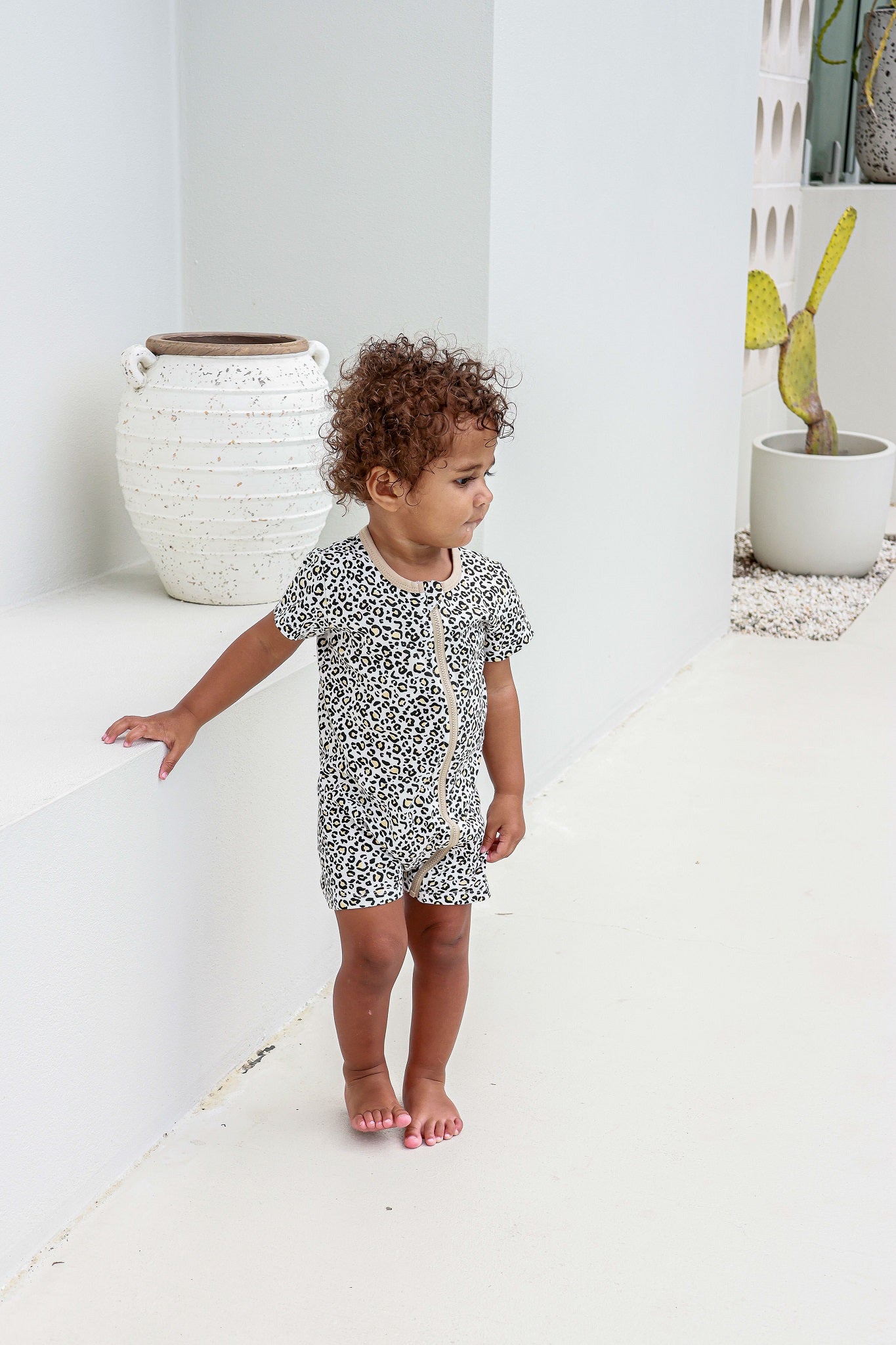 toddler boy wearing leopard print romper pyjamas