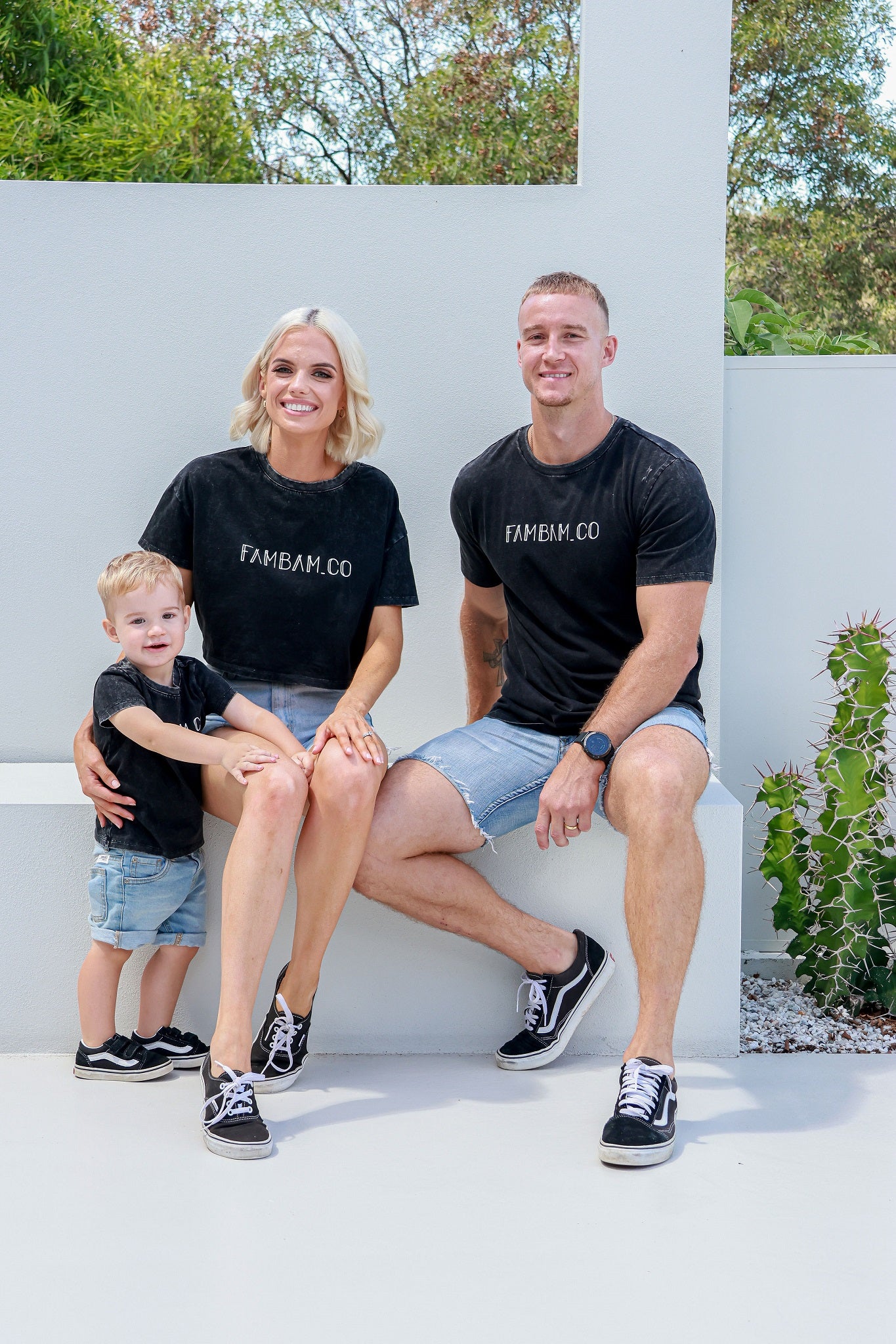 Family wearing matching acid wash logo shirts