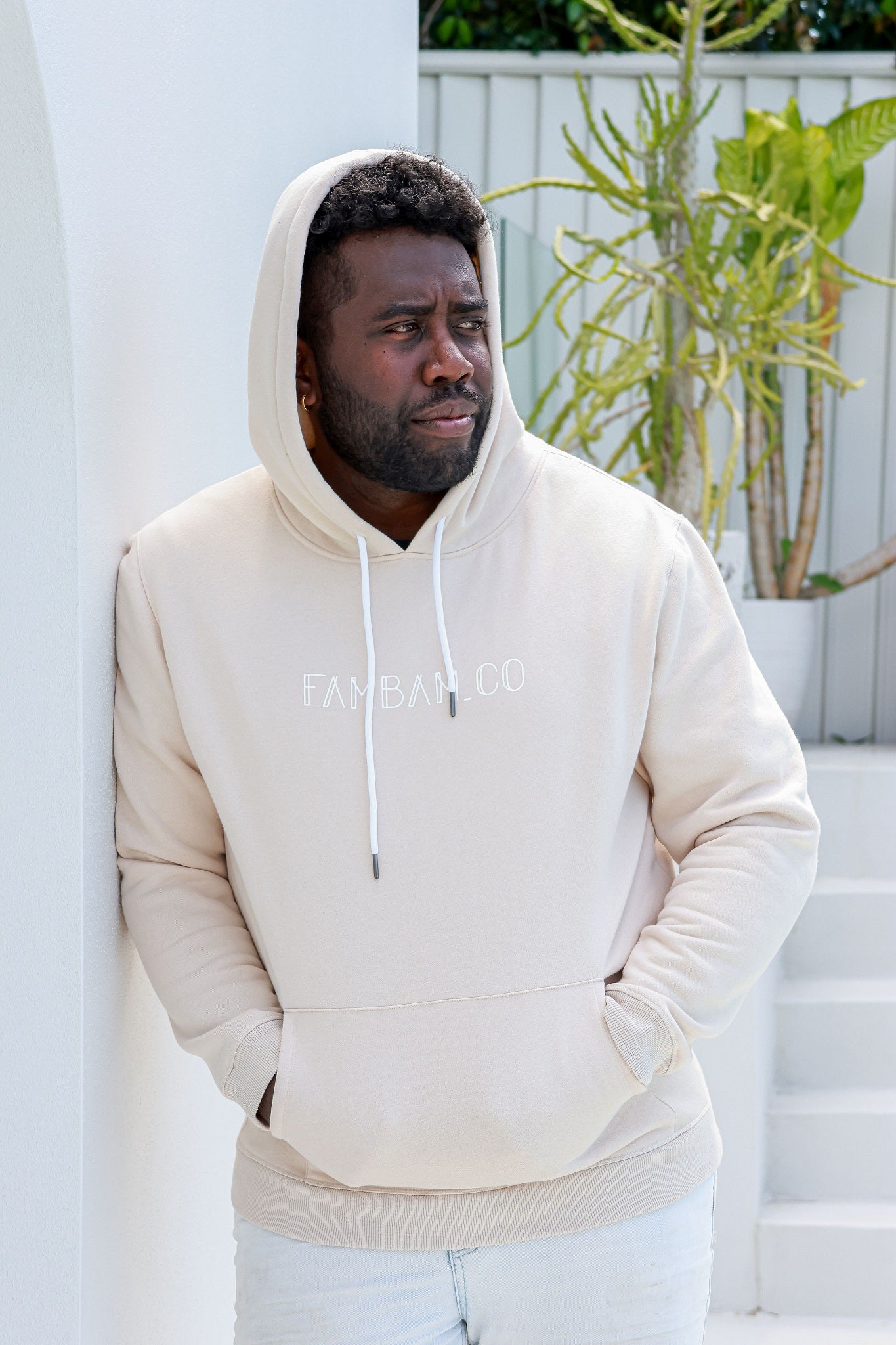 man standing in beige hoodie jumper