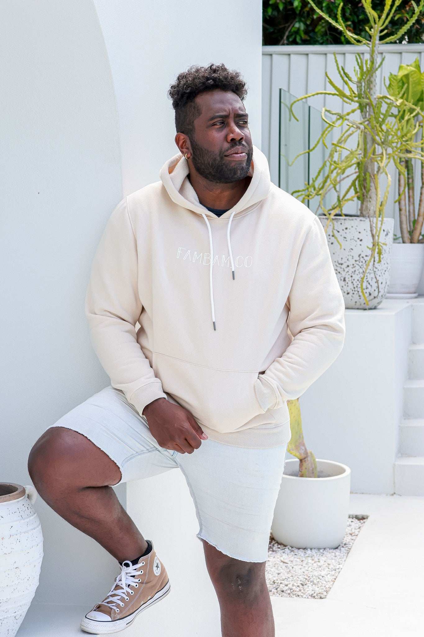 man standing wearing beige hoodie