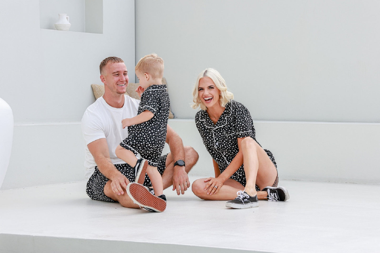 family hanging outside together in matching black and white spotted pyjamas pj's pajamas