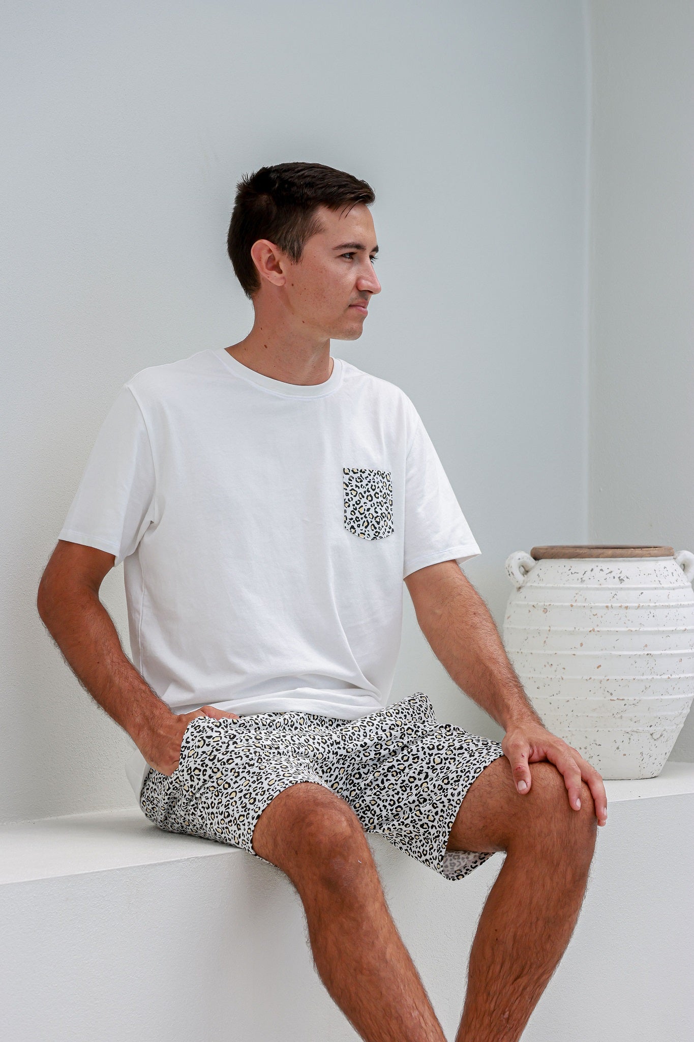 man sitting down wearing leopard print pyjamas pj's pajamas