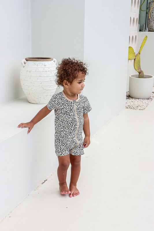 toddler boy wearing leopard print romper pyjamas