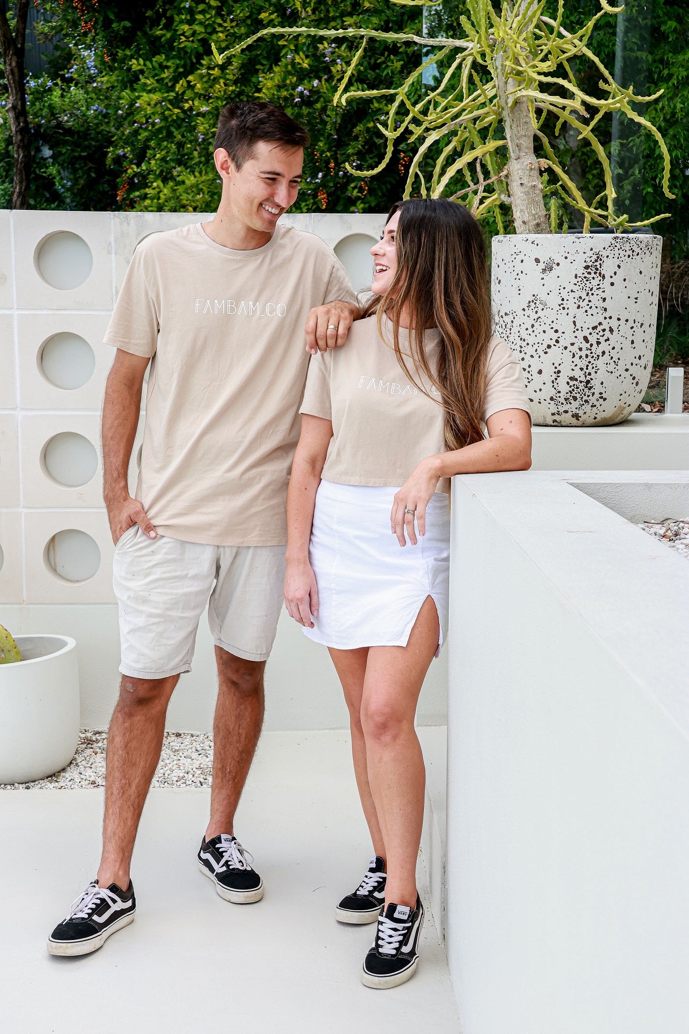 Couple standing together wearing matching shirts in colour beige