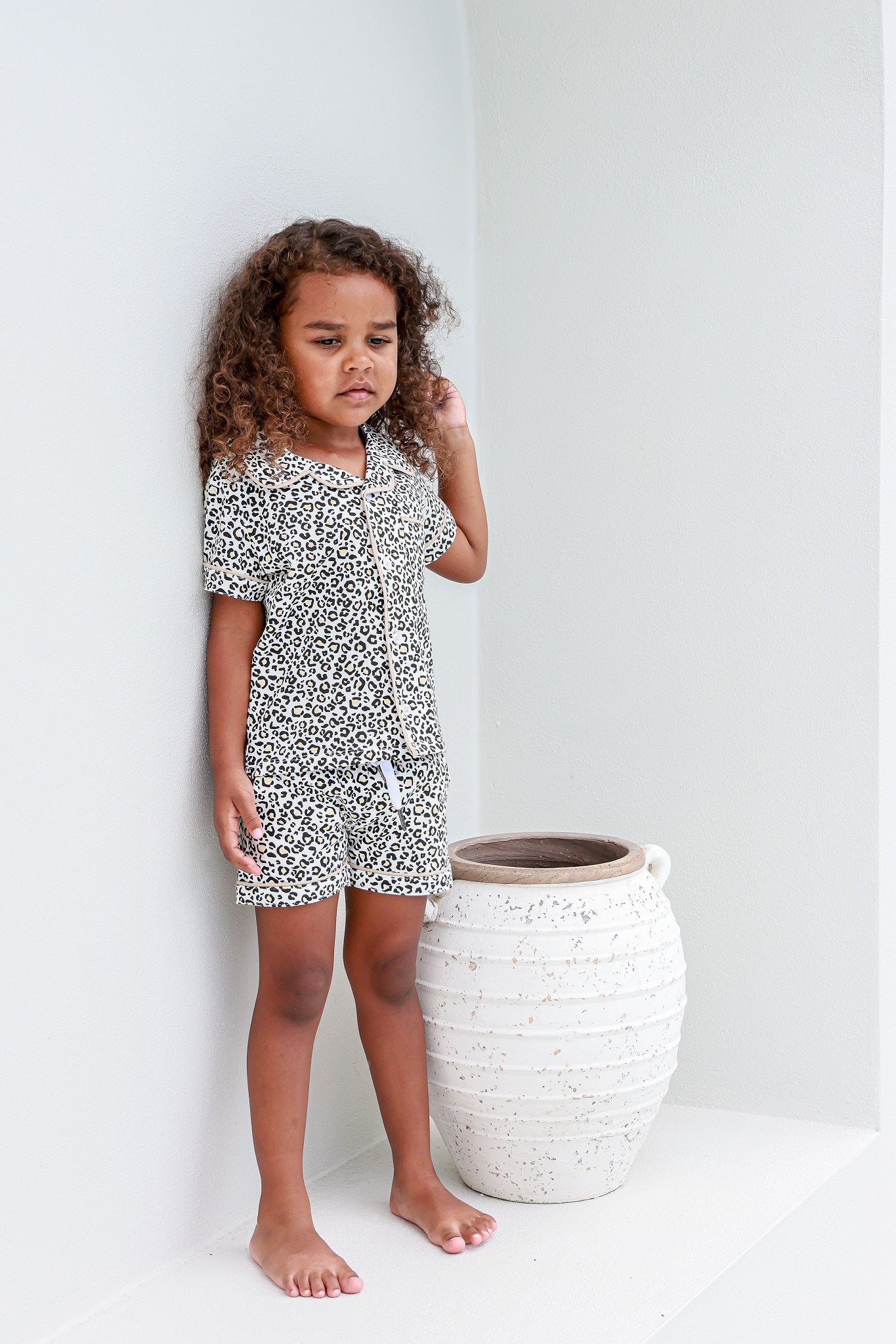 Toddler girl next to vase wearing leopard print pyjama sets pj's pajamas