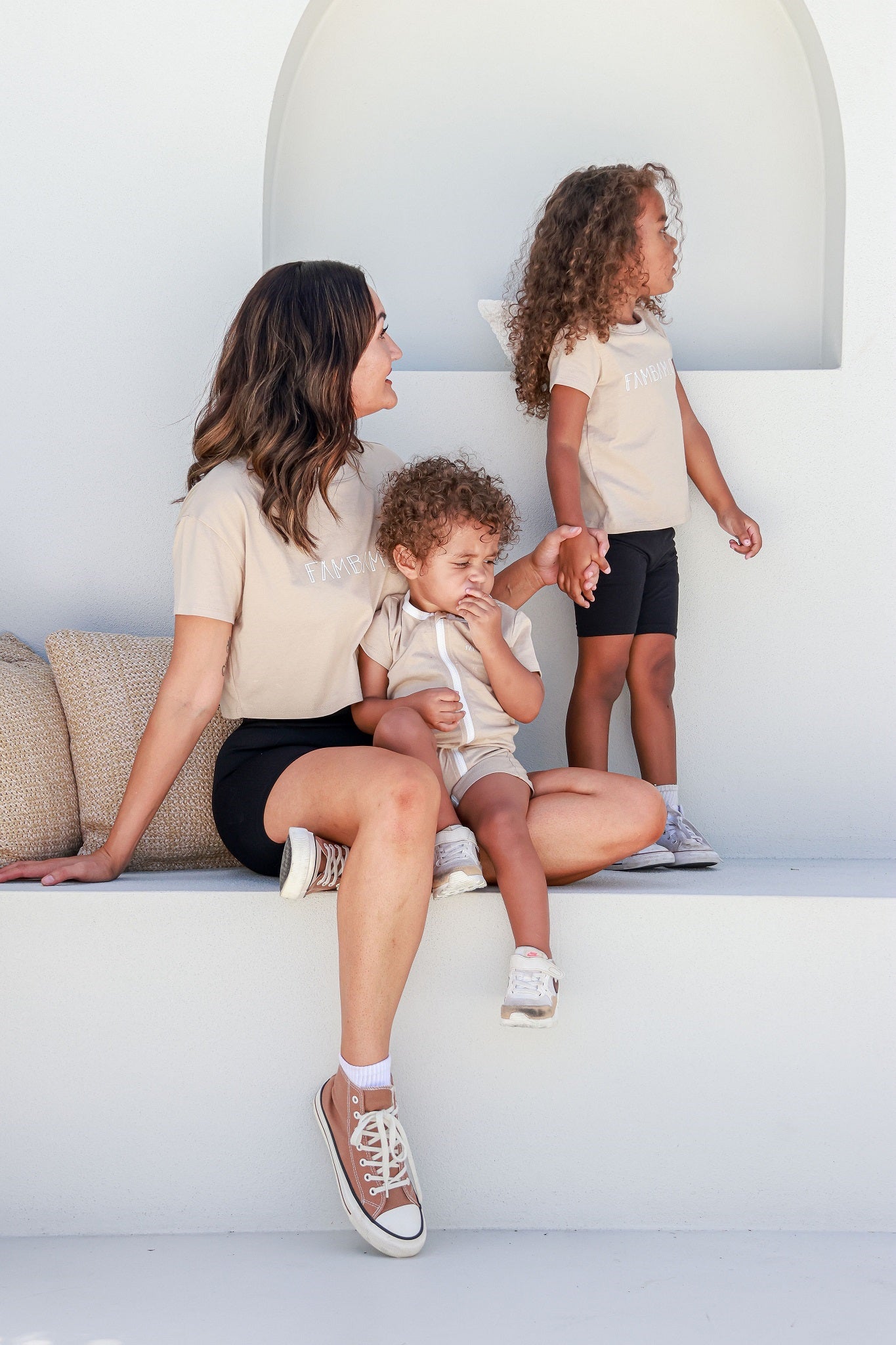 mother with two kids matching in beige outfits